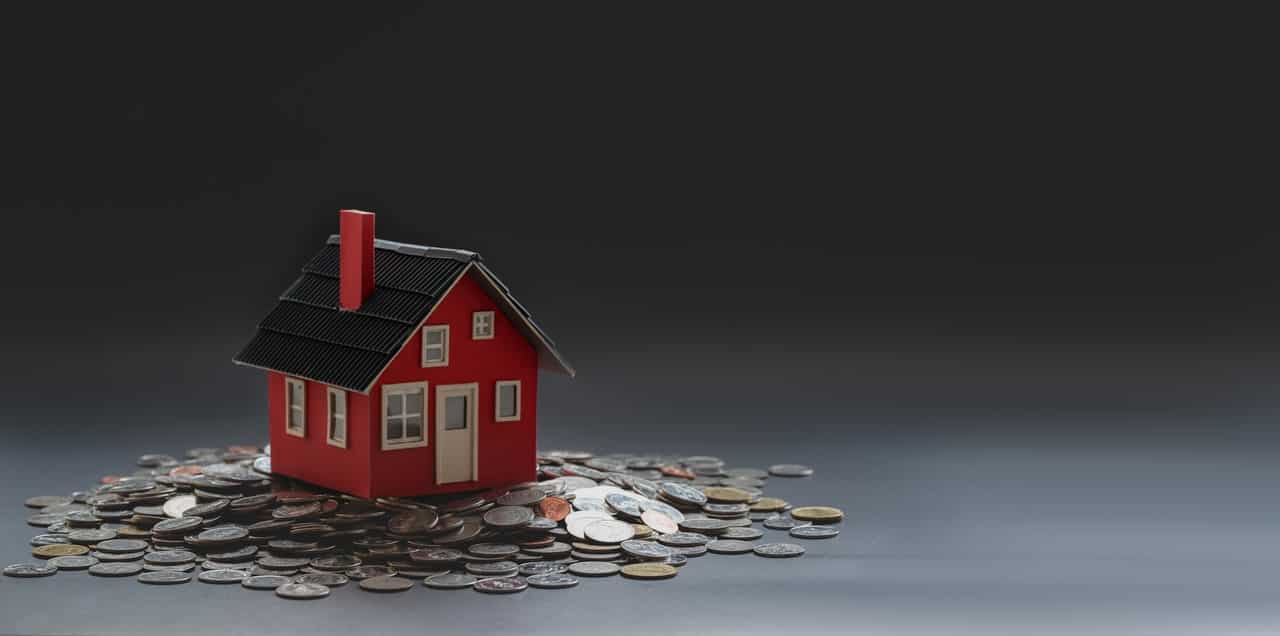 pexels-bongkarn-thanyakij-3740794 Toy house on pile of coins