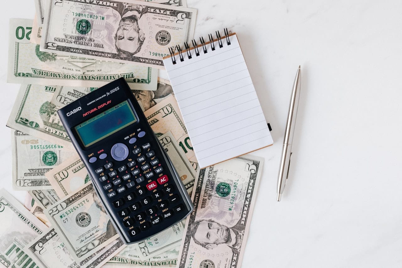 Calculator on top of pile of cash - How often can you refinance your home?