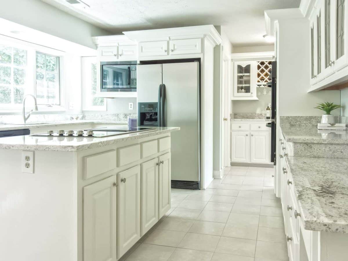 Interior view of a home kitchen designed mostly in white tones