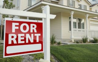 Right Facing Red For Rent Real Estate Sign in Front of Beautiful House.