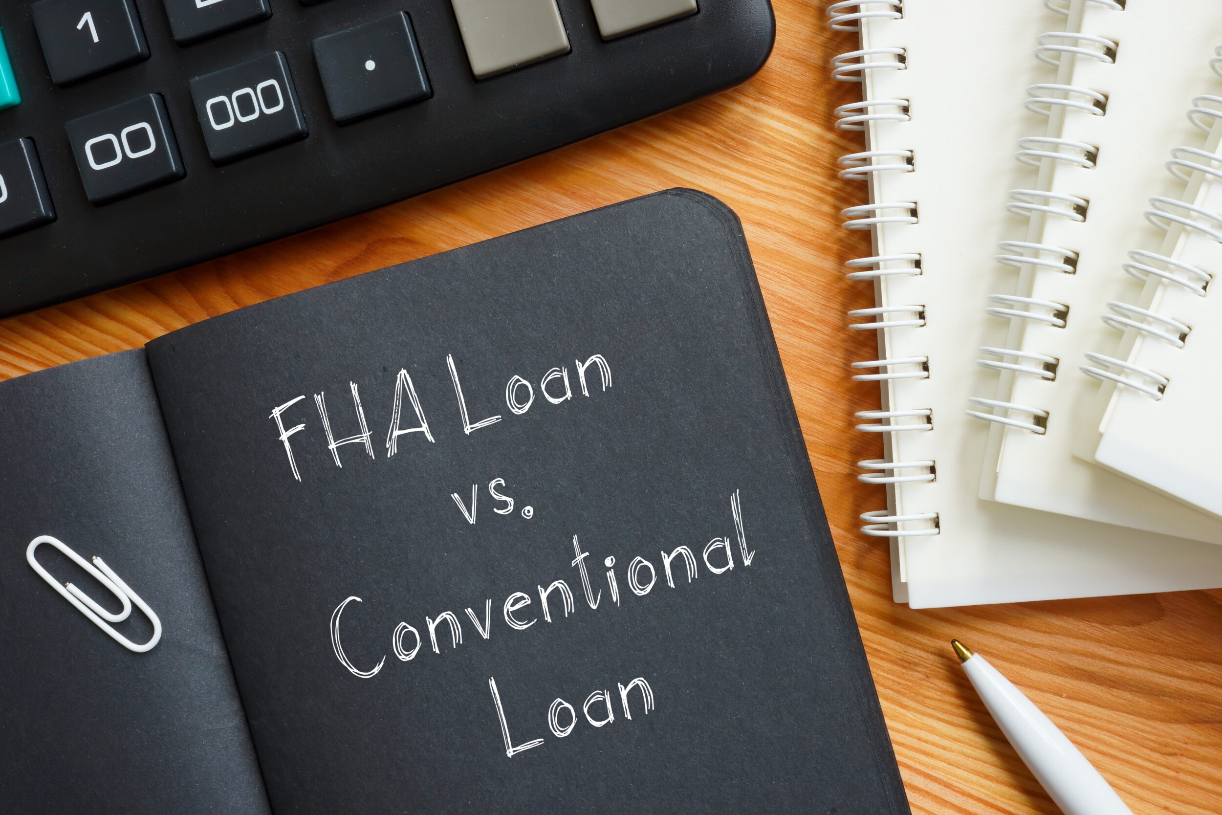 FHA Loan vs. Conventional Loan is shown on the business photo using the text FHA Loan vs. Conventional Loan is shown on a business photo using the text